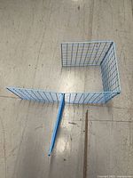 Three of the light blue wire grid panels connected at right angles