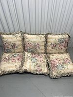 Six floral cushions arranged side by side