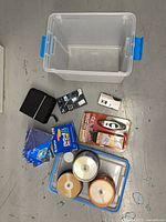 Full lot overview showing storage bin, discs, recorder, tire gauge, screen protector, DVD binder, cases