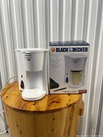 Coffee maker front with original box visible