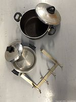 All items: two metal pots with lids, gold over-door rack
