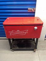 Front view showing logo, dual lid, stand, casters