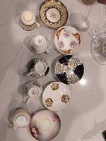 Overhead view showing all five cups and saucers with distinct patterns