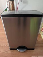 Front view of stainless steel dual-compartment pedal bin