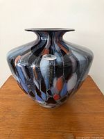 Front view of multicolour handblown glass vase showing Maestri Vetrai label