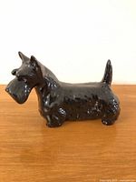 Left side view of glossy black Scottish terrier figurine