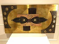Full view of brass-backed mixed metal wall art