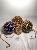 Three glass fishing floats tied together