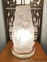 Front view of frosted lucite lamp showing male and female figures illuminated