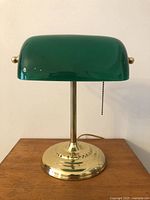 Front view of brass-tone banker’s lamp with green shade