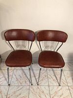 Front view of both vintage chrome and vinyl chairs