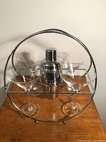 front view of holder with shaker and glasses