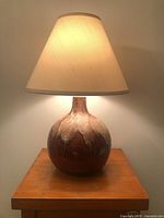 Lamp with shade illuminated on table