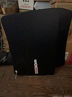 Front view of folded black standing desk converter