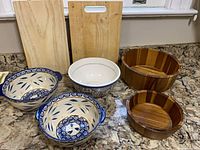 Group view of all items: two cutting boards and five bowls