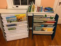 Overall view of two sling bookshelves loaded with children’s books