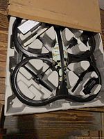 Drone in open box showing foam hull and camouflage body