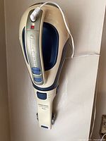 Side view of handheld vacuum on wall-mount