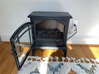 Front view with door open showing simulated logs and controls