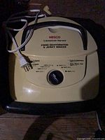 Top view of Nesco American Harvest food dehydrator showing brand label, thermostat dial, handle and power cord