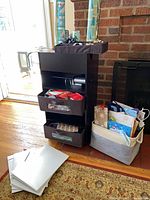 Full view of organizer tower, basket of gift bags, stack of gift boxes