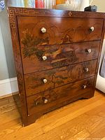Front view showing four drawers with painted Japanese landscape and metal knobs