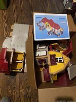Box containing Playmobil house panels and instruction booklet