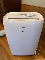 Front view LG portable air conditioner with remote on top