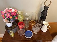 Overall view of all vases, bowls, pitcher, faux flowers and planters on table