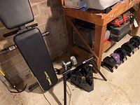 Bench, spin-lock bar, triangular dumbbell cradle and both adjustable dumbbells in situ