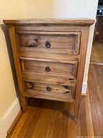 Front view of three-drawer wooden dresser showing size, drawer pulls, finish, and condition