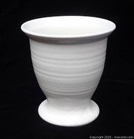 Side view of matte white footed cup
