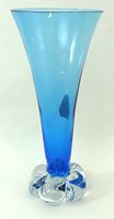 Full view of blue glass vase with clear loop base