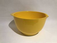 Side view of yellow melamine bowl showing exterior and spout