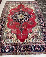 Full view of Persian Tabriz rug showing entire design and colours