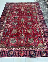 Full view of Persian Tabriz rug showing overall design and borders