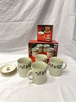 Four mugs and four coasters displayed