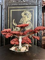 Full view of coral-style tree sculpture with Guanyin and stones