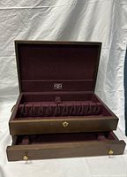 Chest open showing interior slots and pull-out drawer