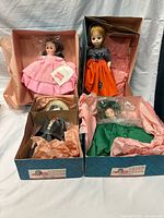Overview of four Madame Alexander dolls in their boxes