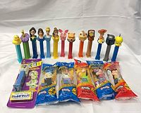 Group shot of ten loose character dispensers standing with six sealed packages laid out