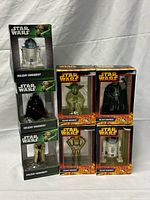 Seven boxed Star Wars ornaments stacked for overview