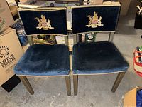 Front view of both chairs showing upholstery, crest, frames