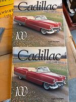 Front covers of both Cadillac books
