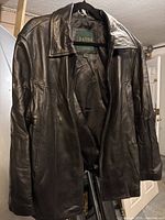 Front view of Danier black leather jacket on hanger