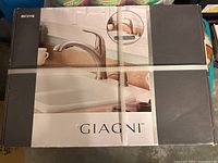 Front of sealed Giagni faucet box showing product image and branding