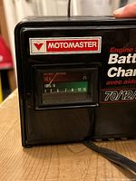 Front view showing Motomaster branding and analog amp meter