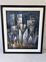 Full view of framed abstract cityscape painting