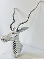 front view of polished aluminum antelope head with long horns