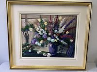 Frontal view of framed floral oil painting